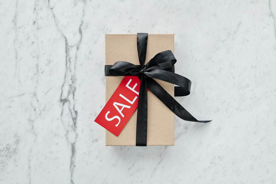A minimalist gift box with a black ribbon and sale tag, perfect for promotions and special offers.