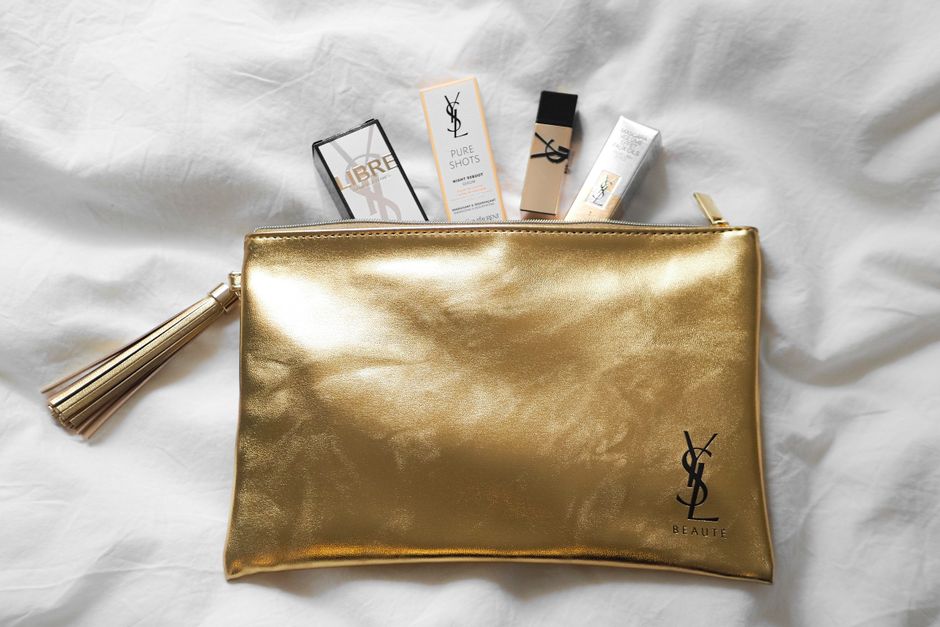 Luxurious YSL beauty products elegantly arranged on a golden pouch.