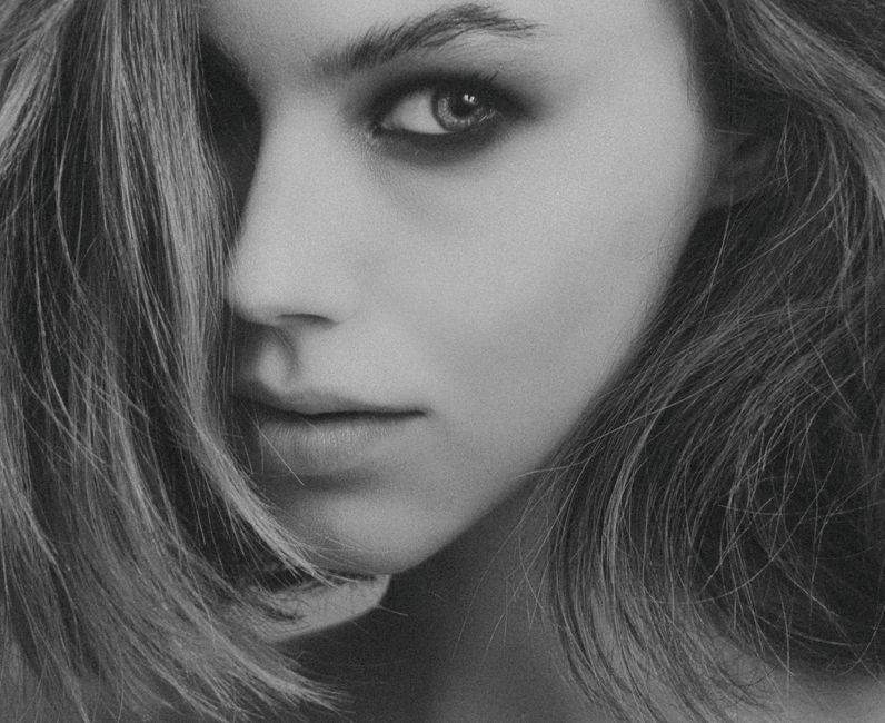 Stunning black and white close-up portrait of a woman with captivating eyes.